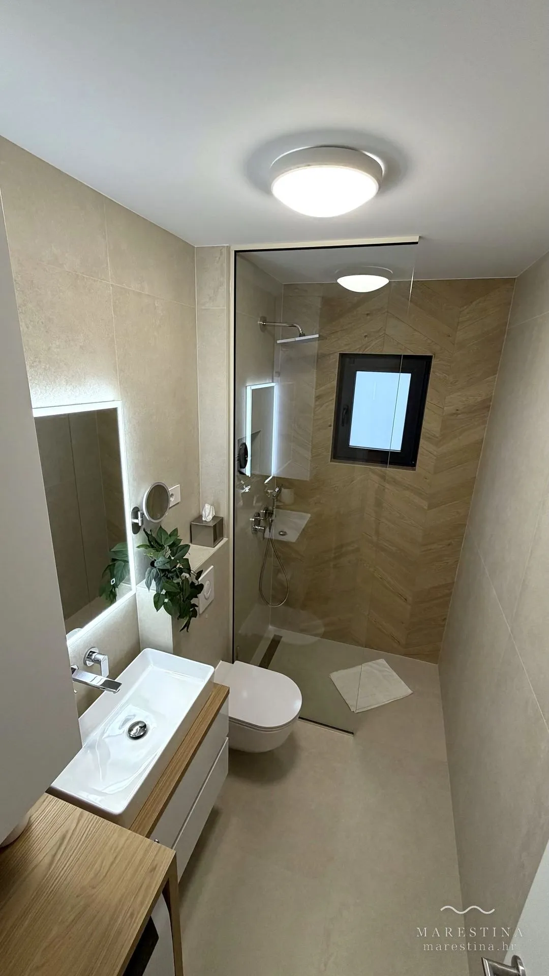Second bathroom with walk-in shower and washing machine